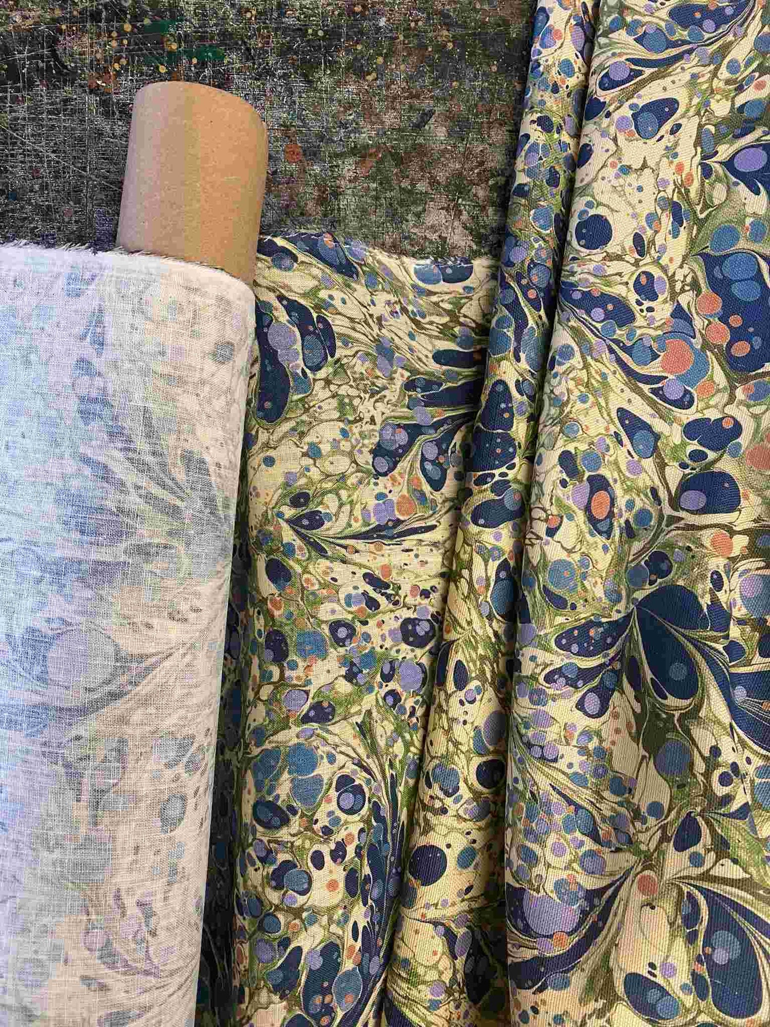 House of Amitié Juniper Blue Anise digitally marbled printed fabric made from 100% Linen sourced from Belgium. Shown on the roll, available by the metre and made within the UK.