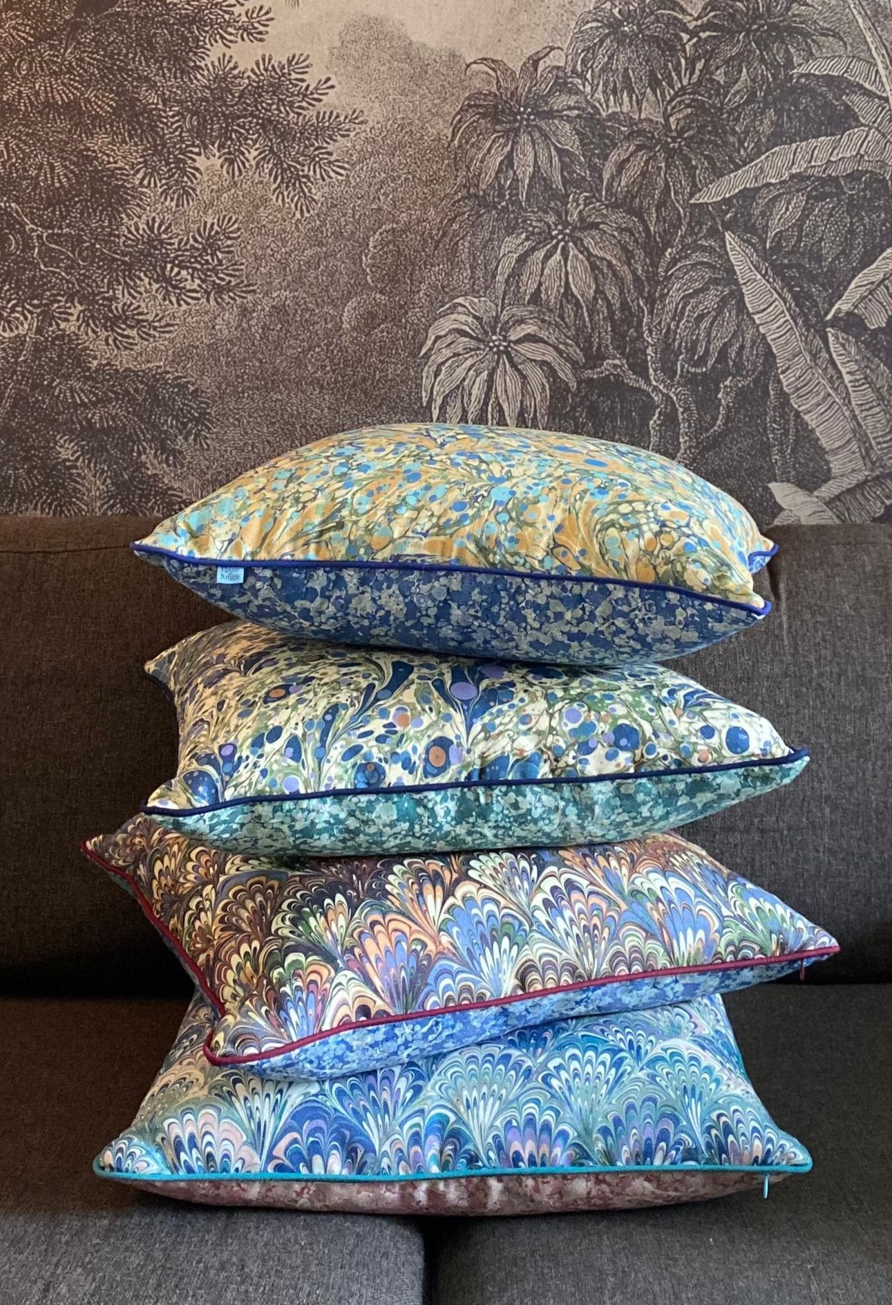 A selection of House of Amitié marbled printed cushions made from Linen Cotton Union fabric that's woven and printed and made into cushion covers in the UK.